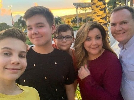 Brady is taking a selfie picture with his family.